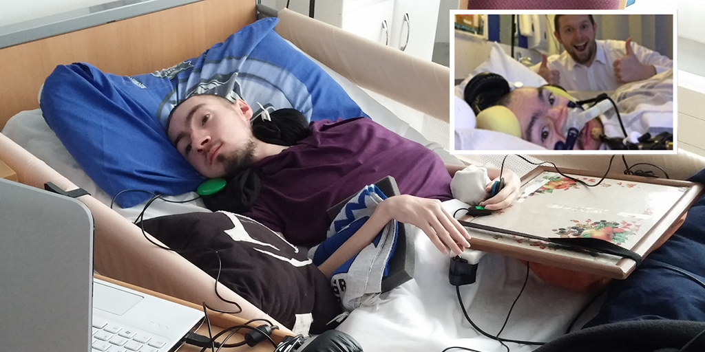 man lying in bed using adapted computer controller