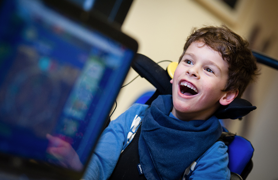 smiling boy with computer screen