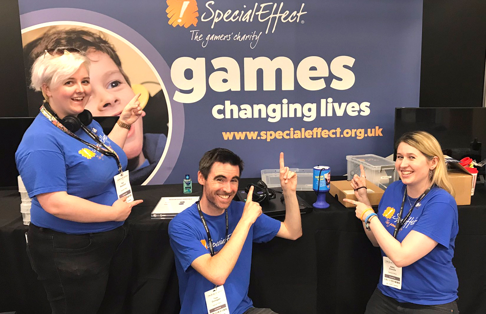 three people at exhibition stand