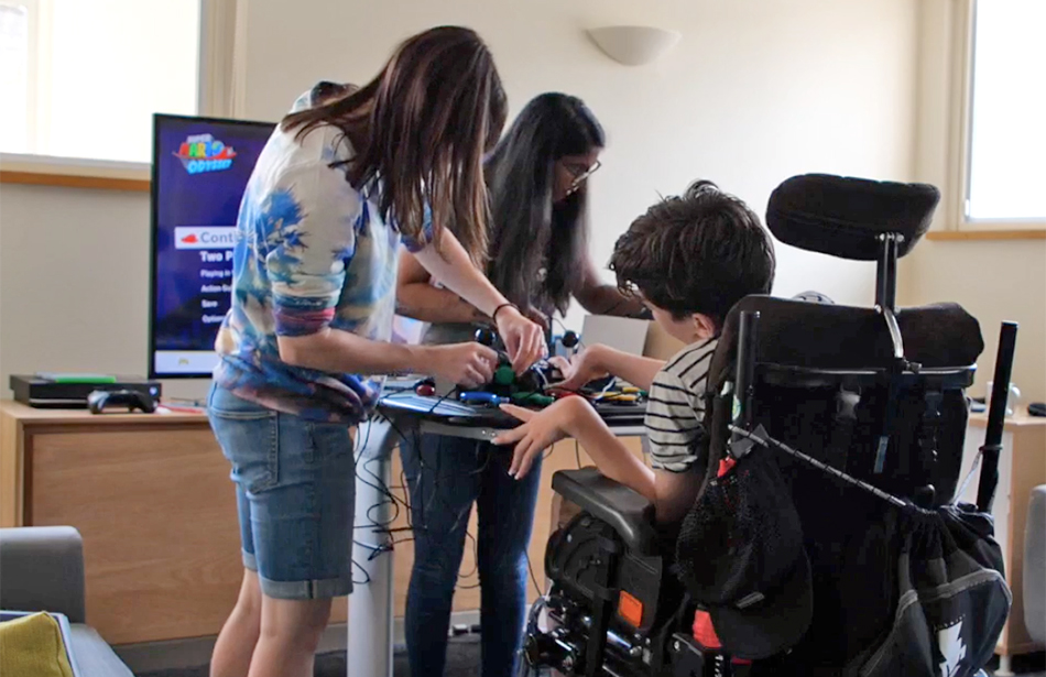 two adults and boy in wheelchair