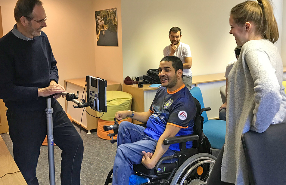 group of figures around man in wheelchair