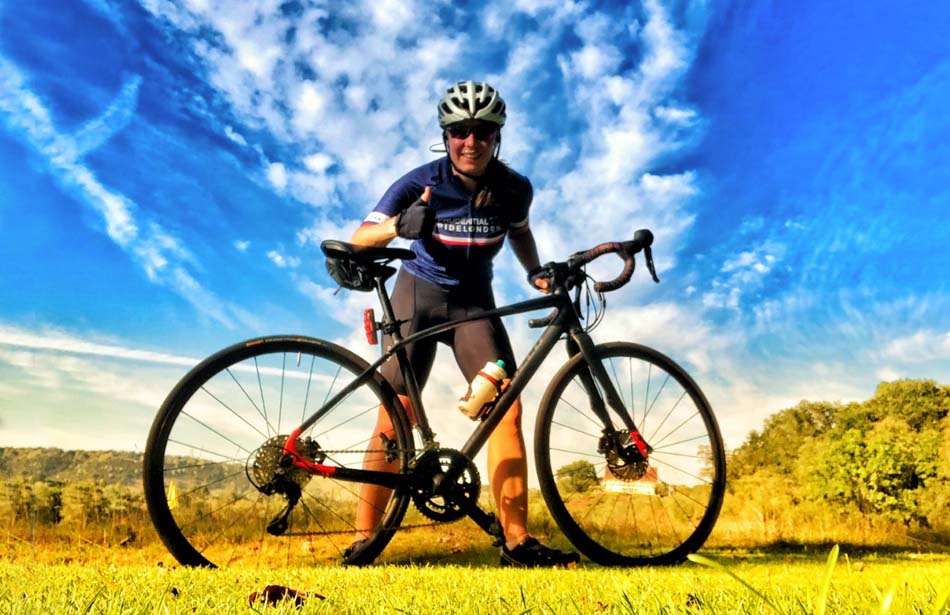 Smiling girl holding bike