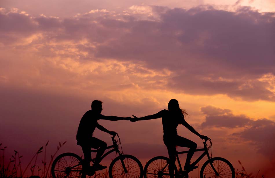 silhouette of two cyclists