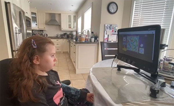 Seated girl looking at computer screen