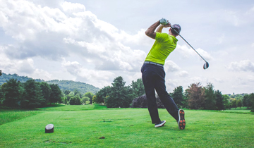 Golfer hitting ball