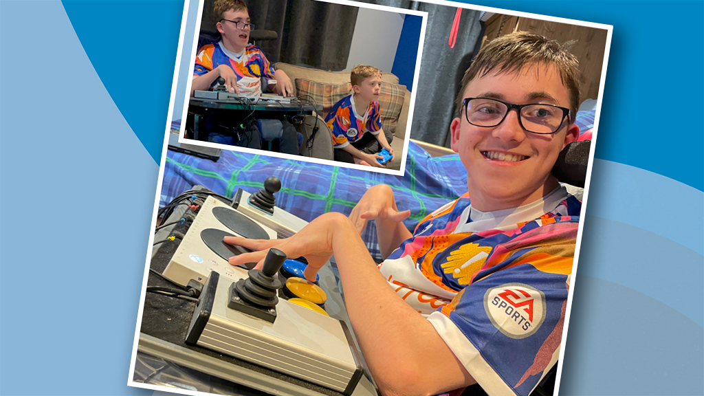smiling boy in wheelchair with adapted gaming controller