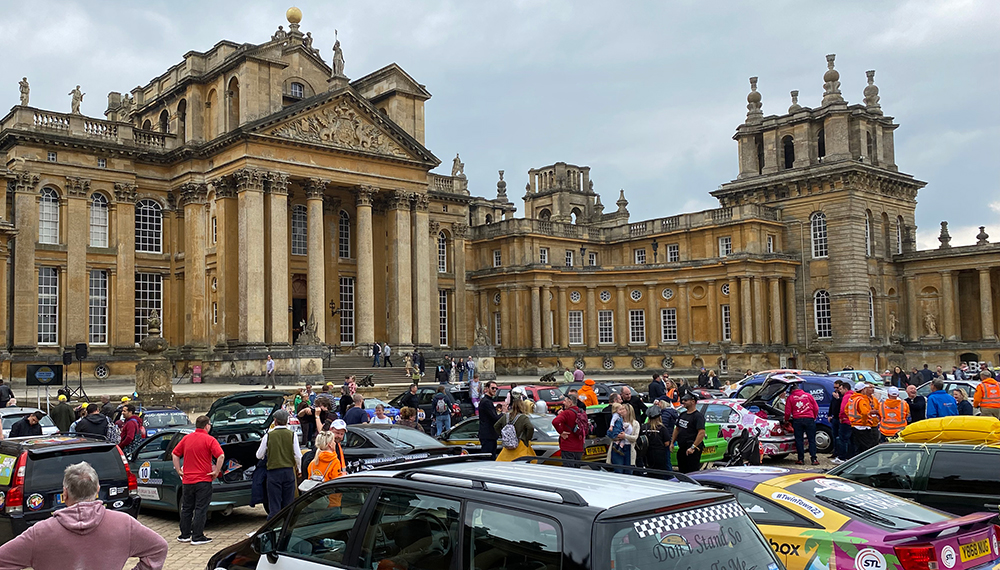 rows of cars in a stately home courtyard