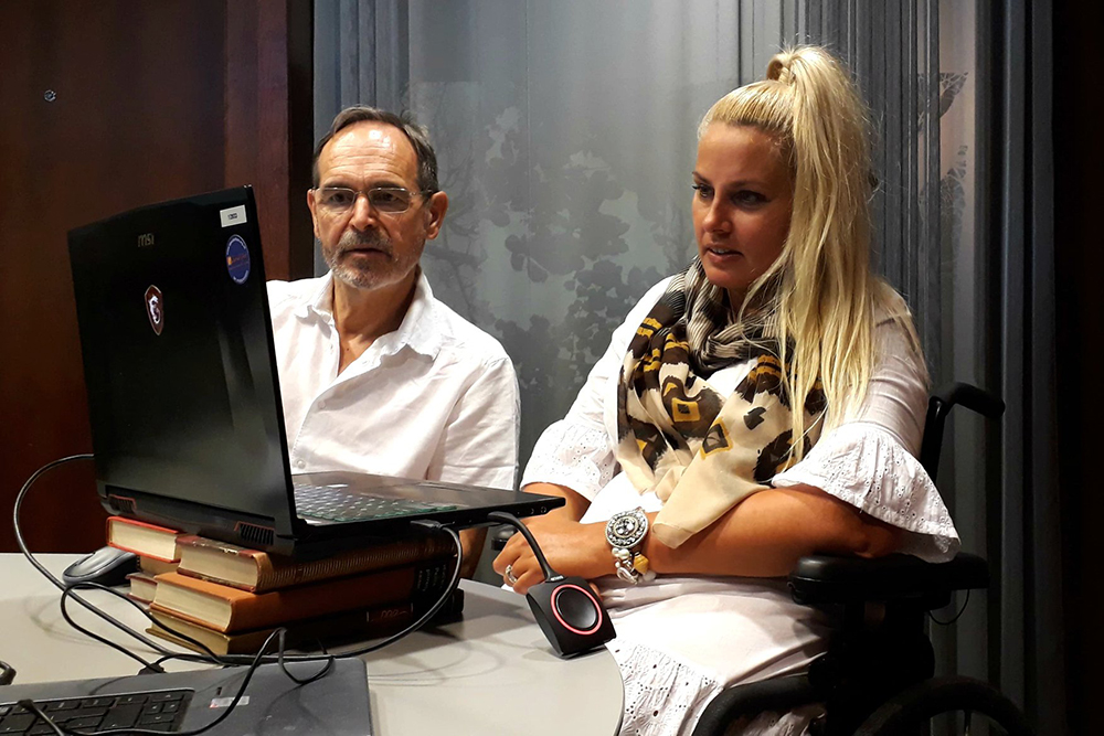 Seated man and woman looking at a computer screen