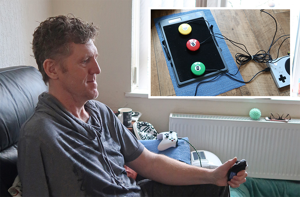 Seated man holding mini games controller