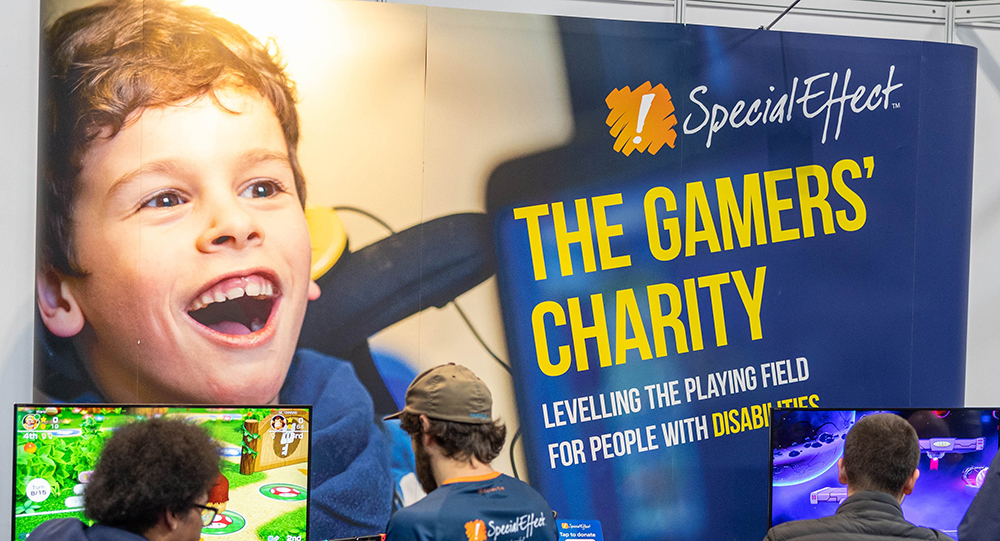 Large exhibition stand prominently featuring the smiling face of a young child