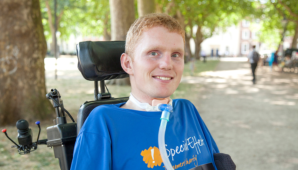 Close up of smiling man in wheelchair wearing SpecialEffect branded tee shirt 