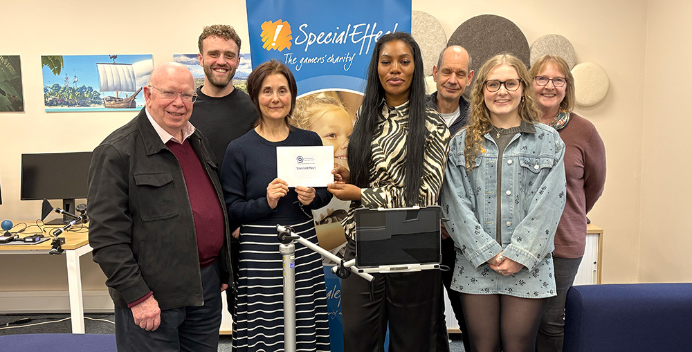 Seven people pose for cheque presentation